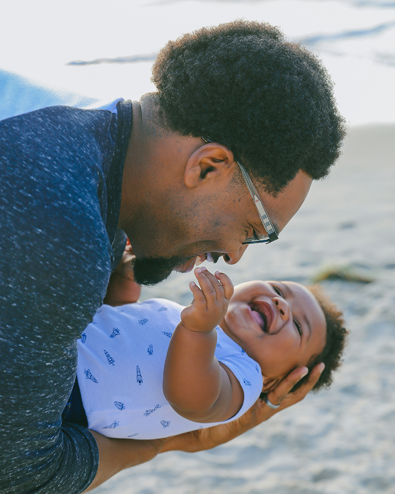 Young father holding his baby boy.